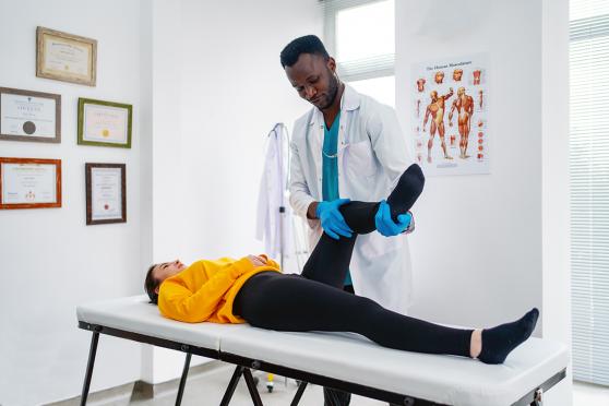 Doctor checking a patient for leg pain